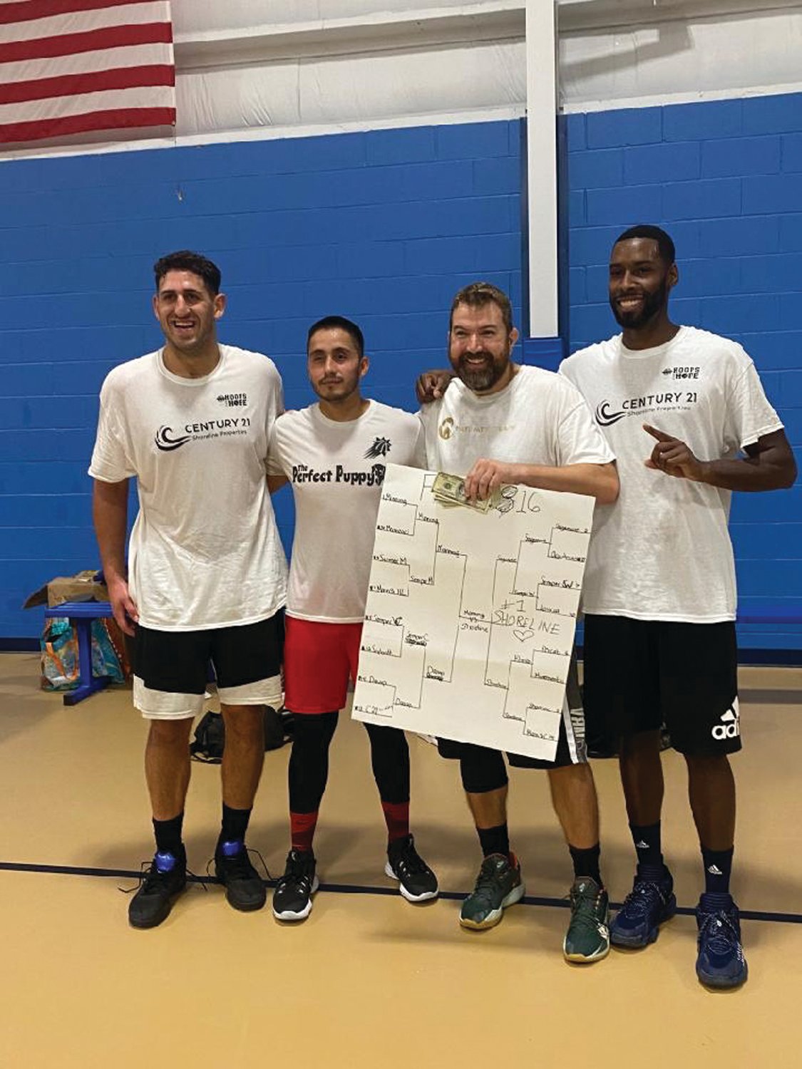 THE CHAMPIONS: The champions of last month’s Hoops for Hope tournament – Isaac Belovitch, Carlos Munoz, Matt Patty and Steve Lopes – share a moment after the event. The team returned their $500 prize to the event’s fundraising total.